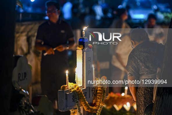 Christian devotees light candles by the grave of a relative during All Souls' Day at a graveyard in Dhaka, Bangladesh, on November 2, 2025.  by Zabed Hasnain Chowdhury/NurPhoto