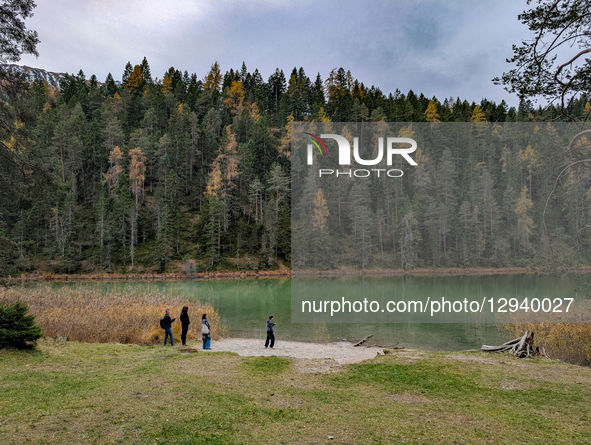 A family is on the shore of the clear, green Lake Mittersee near Biberwier, Tyrol, Austria, on November 1, 2025. The area is a popular touri... by Michael Nguyen/NurPhoto