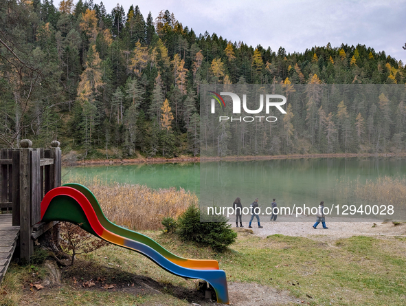 A family stands on the shore of the clear, green Lake Mittersee near Biberwier, Tyrol, Austria, on November 1, 2025. The area is a popular t... by Michael Nguyen/NurPhoto