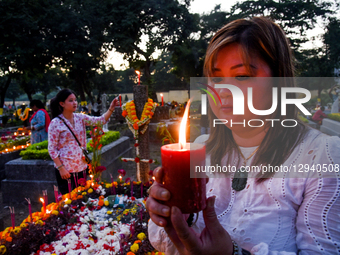 Indian Christians pay tribute at the graves of their loved ones on All Souls Day in Kolkata, India, on November 2, 2025. The day honors the... by Debajyoti Chakraborty/NurPhoto