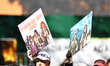 People hold up placards to support friends on First Avenue during the 2025 New York City M...