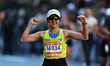 Runner Cinthya Miranda from Managua cheers as she heads up First Avenue during the 2025 Ne...