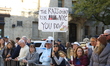 People hold up placards to support friends on First Avenue during the 2025 New York City M...