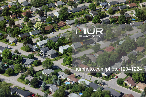 An elevated view shows houses in a neighborhood in Quebec, Canada, on June 22, 2025.  by Creative Touch Imaging Ltd/NurPhoto