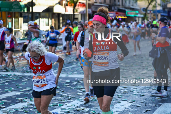 Runners Paola Bianchini and Federica Rosadini from Italy try to ignore the pain as they reach the 16th mile point of the 2025 New York City... by Gordon Donovan/NurPhoto