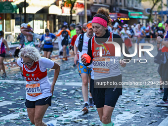 Runners Paola Bianchini and Federica Rosadini from Italy try to ignore the pain as they reach the 16th mile point of the 2025 New York City... by Gordon Donovan/NurPhoto