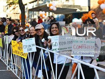 People hold up placards to support friends running in the 2024 New York City Marathon in New York City, United States, on November 2, 2025.  by Gordon Donovan/NurPhoto