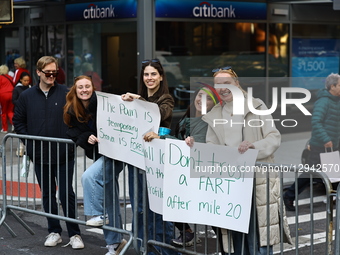 People hold up placards to support friends running in the 2024 New York City Marathon in New York City, United States, on November 2, 2025.  by Gordon Donovan/NurPhoto