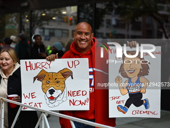 People hold up placards to support friends running in the 2024 New York City Marathon in New York City, United States, on November 2, 2025.  by Gordon Donovan/NurPhoto