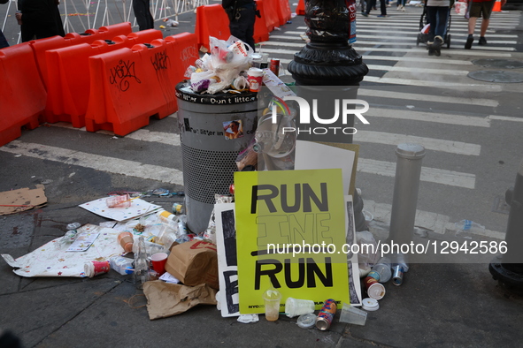 Garbage overflows from a trash can on First Avenue following the completion of the 2025 New York City Marathon in the Upper East Side neighb... by Gordon Donovan/NurPhoto