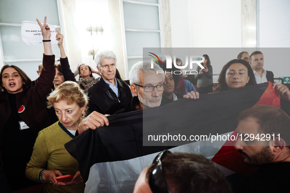 Carlo Monguzzi, a Municipal Councilor, holds a Palestinian flag during the City Council meeting for the vote on the motion to interrupt the... by Alessandro Bremec/NurPhoto