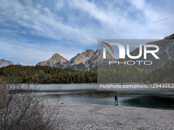 The Zugspitze massif of the Wetterstein Mountains towers over Lake Blindsee and its surrounding autumnal forests in Biberwier, Tyrol, Austri... by Michael Nguyen/NurPhoto