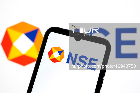 The NSE - National Stock Exchange of India logo appears on a smartphone screen and as the background on a laptop computer screen in this pho... by Nikolas Kokovlis/NurPhoto