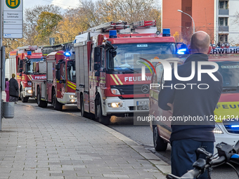 A convoy of emergency vehicles, including fire engines, lines a street with blue flashing lights in Munich, Bavaria, Germany, on November 3,... by Michael Nguyen/NurPhoto