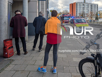 A convoy of emergency vehicles, including fire engines, lines a street with blue flashing lights in Munich, Bavaria, Germany, on November 3,... by Michael Nguyen/NurPhoto