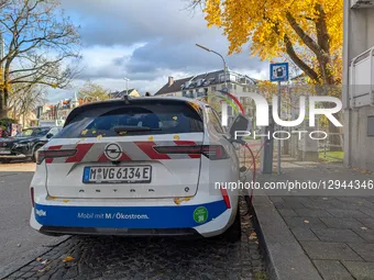 An electric vehicle charges at a public charging station in Munich, Bavaria, Germany, on November 3, 2025.  by Michael Nguyen/NurPhoto
