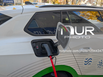 An electric vehicle charges at a public charging station in Munich, Bavaria, Germany, on November 3, 2025.  by Michael Nguyen/NurPhoto
