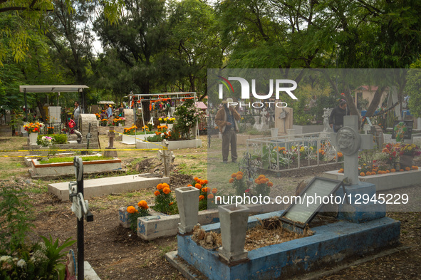 People attend the Municipal Cemetery to keep vigil and decorate the graves of their deceased loved ones on the Day of the Dead in Queretaro,... by Eyepix/NurPhoto