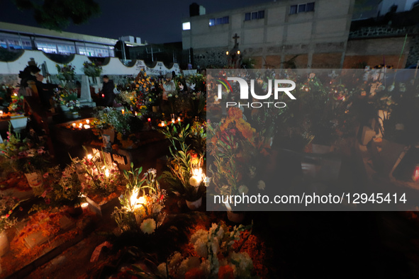 People visit the San Andres Mixquic cemetery, located in Tlahuac, to accompany their deceased loved ones in the traditional lighting ceremon... by Eyepix/NurPhoto
