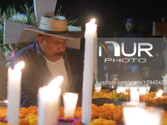 People visit the San Andres Mixquic cemetery, located in Tlahuac, to accompany their deceased loved ones in the traditional lighting ceremon... by Eyepix/NurPhoto