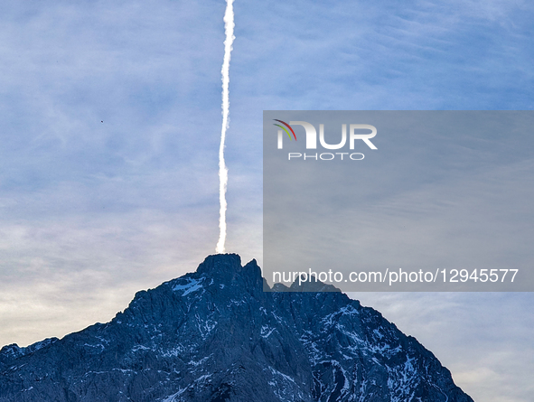 A vertical contrail from an aircraft streaks directly upward from a snow-dusted Alpine peak in Lermoos, Tyrol, Austria, on November 1, 2025.... by Michael Nguyen/NurPhoto