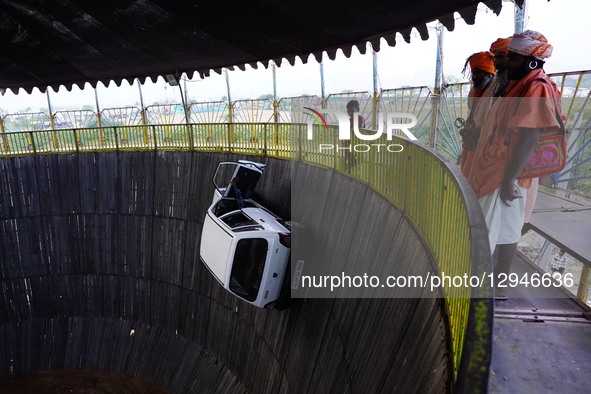 Stuntmen ride their vehicles along the wall of a wooden structure during the 'Well of Death' show at a fair in Pushkar, India, on November 3... by Himanshu Sharma/NurPhoto