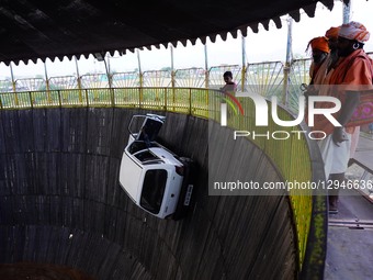 Stuntmen ride their vehicles along the wall of a wooden structure during the 'Well of Death' show at a fair in Pushkar, India, on November 3... by Himanshu Sharma/NurPhoto