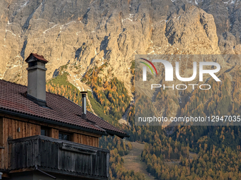 The rocky peaks of the Zugspitze massif catch the last light of day, towering over the village houses in Ehrwald, Tyrol, Austria, on Novembe... by Michael Nguyen/NurPhoto