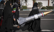 Veiled Iranian women carry a scale model of an Iran-made ballistic missile during an anti-...