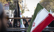 Veiled Iranian students stand behind scale models of Iran-made ballistic missiles and a co...