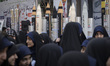Veiled Iranian students gather in front of scale models of Iran-made ballistic missiles an...