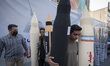 Unidentified men carry scale models of Iran-made ballistic missiles after an anti-U.S. and...