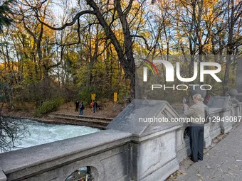 The famous Eisbach wave is gone. Spectators watch the flat river water of the Eisbach in Munich, Bavaria, Germany, on November 4, 2025. Surf... by Michael Nguyen/NurPhoto