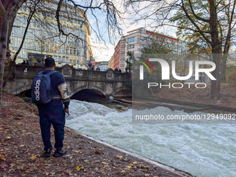 The famous Eisbach wave is gone. Spectators watch the flat river water of the Eisbach in Munich, Bavaria, Germany, on November 4, 2025. Surf... by Michael Nguyen/NurPhoto