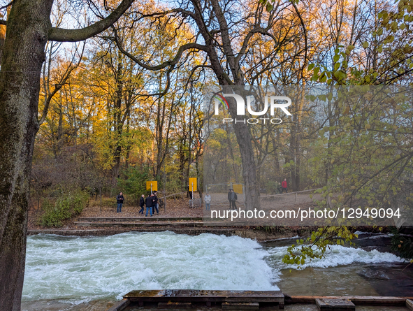 The famous Eisbach wave is gone. Spectators watch the flat river water of the Eisbach in Munich, Bavaria, Germany, on November 4, 2025. Surf... by Michael Nguyen/NurPhoto