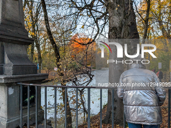 The famous Eisbach wave is gone. Spectators watch the flat river water of the Eisbach in Munich, Bavaria, Germany, on November 4, 2025. Surf... by Michael Nguyen/NurPhoto