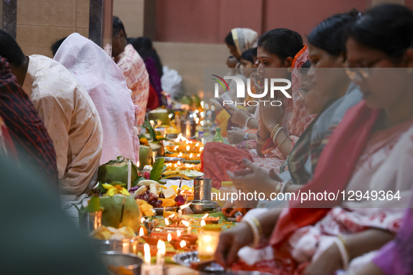 Hindu devotees sit together with oil lamps to pray to Lokenath Brahmachari, a Hindu saint and philosopher, as they observe the Rakher Upobas... by Kazi Salahuddin Razu/NurPhoto