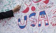 An Iranian student signs an anti-U.S. banner during an anti-American and anti-Israeli rall...