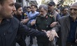 General Mohsen Rezaee, a member of the Expediency Discernment Council of Iran, walks along...