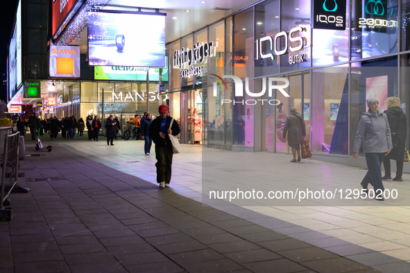 People walk past shops in the city center in Warsaw, Poland, on November 4, 2025.  by Aleksander Kalka/NurPhoto