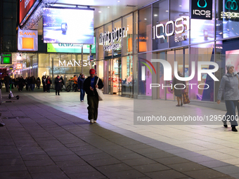 People walk past shops in the city center in Warsaw, Poland, on November 4, 2025.  by Aleksander Kalka/NurPhoto