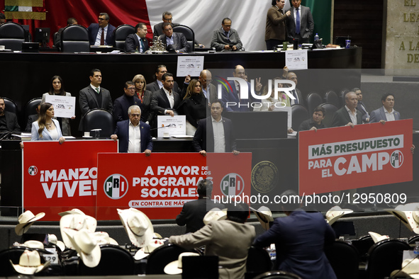 Legislators from the Institutional Revolutionary Party (PRI) hold placards against the murder of Uruapan Mayor Carlos Manzo during a session... by Eyepix/NurPhoto