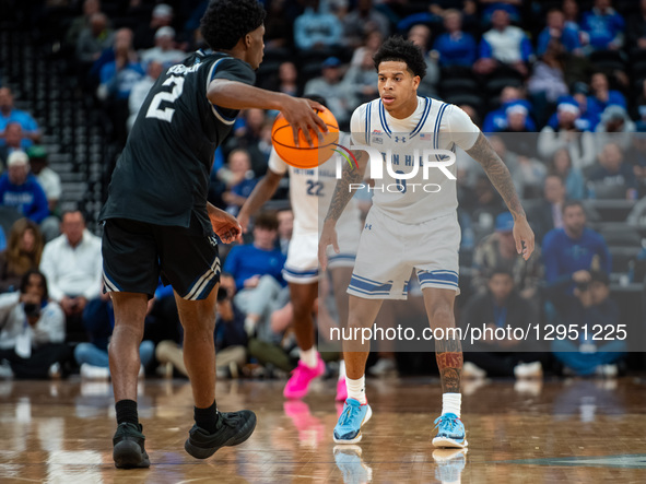 Budd Clark (0) plays defense for the Seton Hall Pirates against TJ Robinson (2) of the Saint Peter's Peacocks during an NCAA basketball game... by Dan Squicciarini/NurPhoto