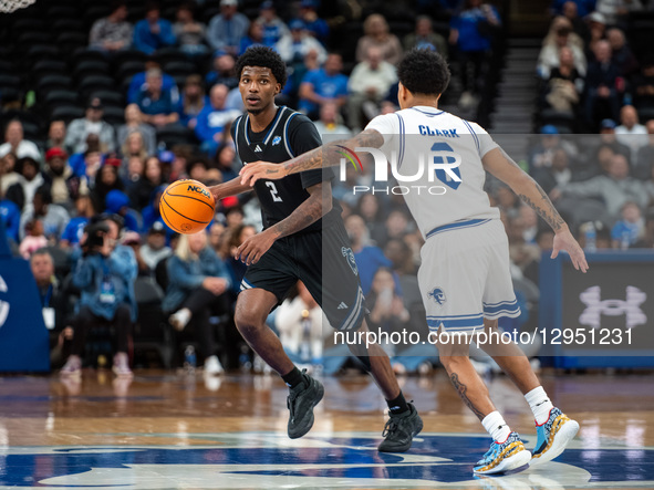 TJ Robinson possesses the ball for the Saint Peter's Peacocks during an NCAA basketball game at Prudential Center in Newark, United States,... by Dan Squicciarini/NurPhoto