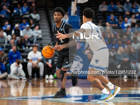 TJ Robinson possesses the ball for the Saint Peter's Peacocks during an NCAA basketball game at Prudential Center in Newark, United States,... by Dan Squicciarini/NurPhoto