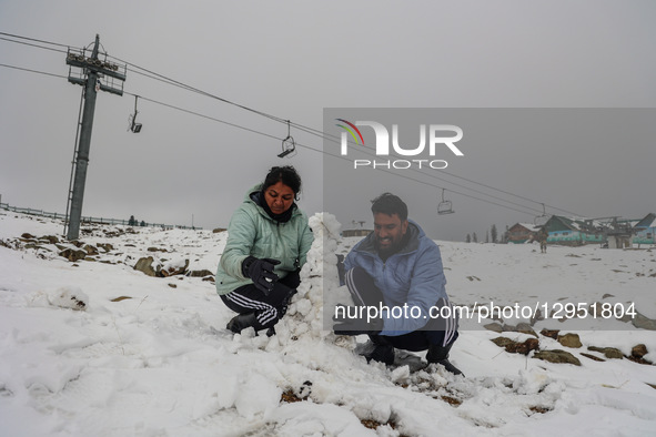 A couple makes a snowman at Gulmarg, a renowned ski resort in Jammu and Kashmir, India, on November 5, 2025, during the season's first snowf... by Nasir Kachroo/NurPhoto