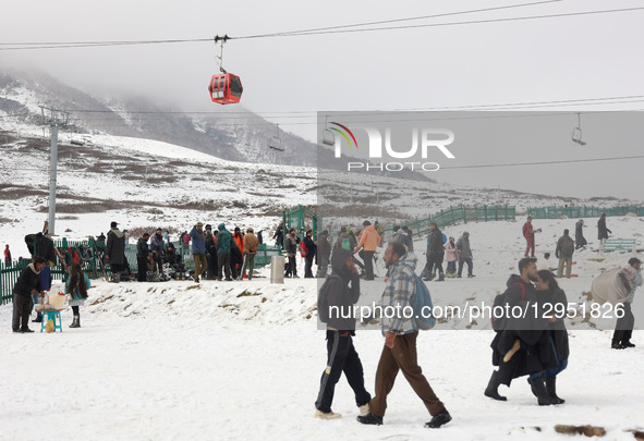 Tourists flock to Gulmarg, a renowned ski resort in Jammu and Kashmir, India, on November 5, 2025, to experience the season's first snowfall... by Nasir Kachroo/NurPhoto