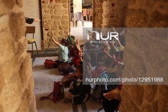 Palestinian children attend a class in the historic ''Al-Kamaliya al-Othmanya'' school in Gaza City's Old Town as part of a volunteer initia... by Majdi Fathi/NurPhoto