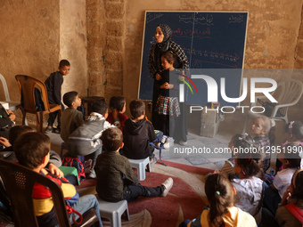 Palestinian children attend a class in the historic ''Al-Kamaliya al-Othmanya'' school in Gaza City's Old Town as part of a volunteer initia... by Majdi Fathi/NurPhoto