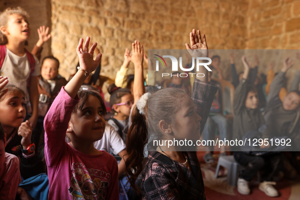 Palestinian children attend a class in the historic ''Al-Kamaliya al-Othmanya'' school in Gaza City's Old Town as part of a volunteer initia...